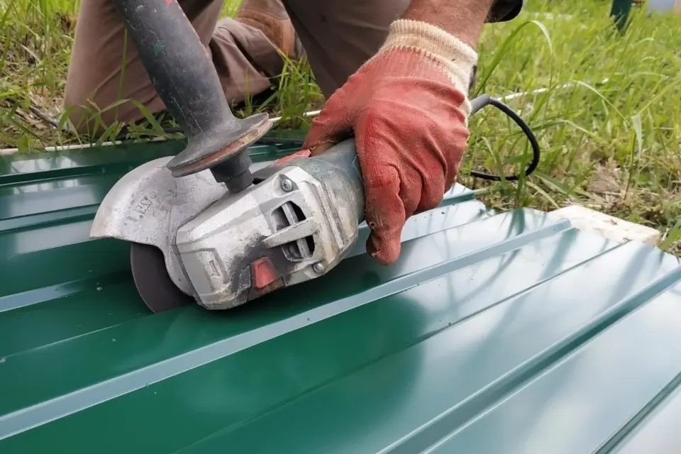 Cutting metal roof panel with grinder
