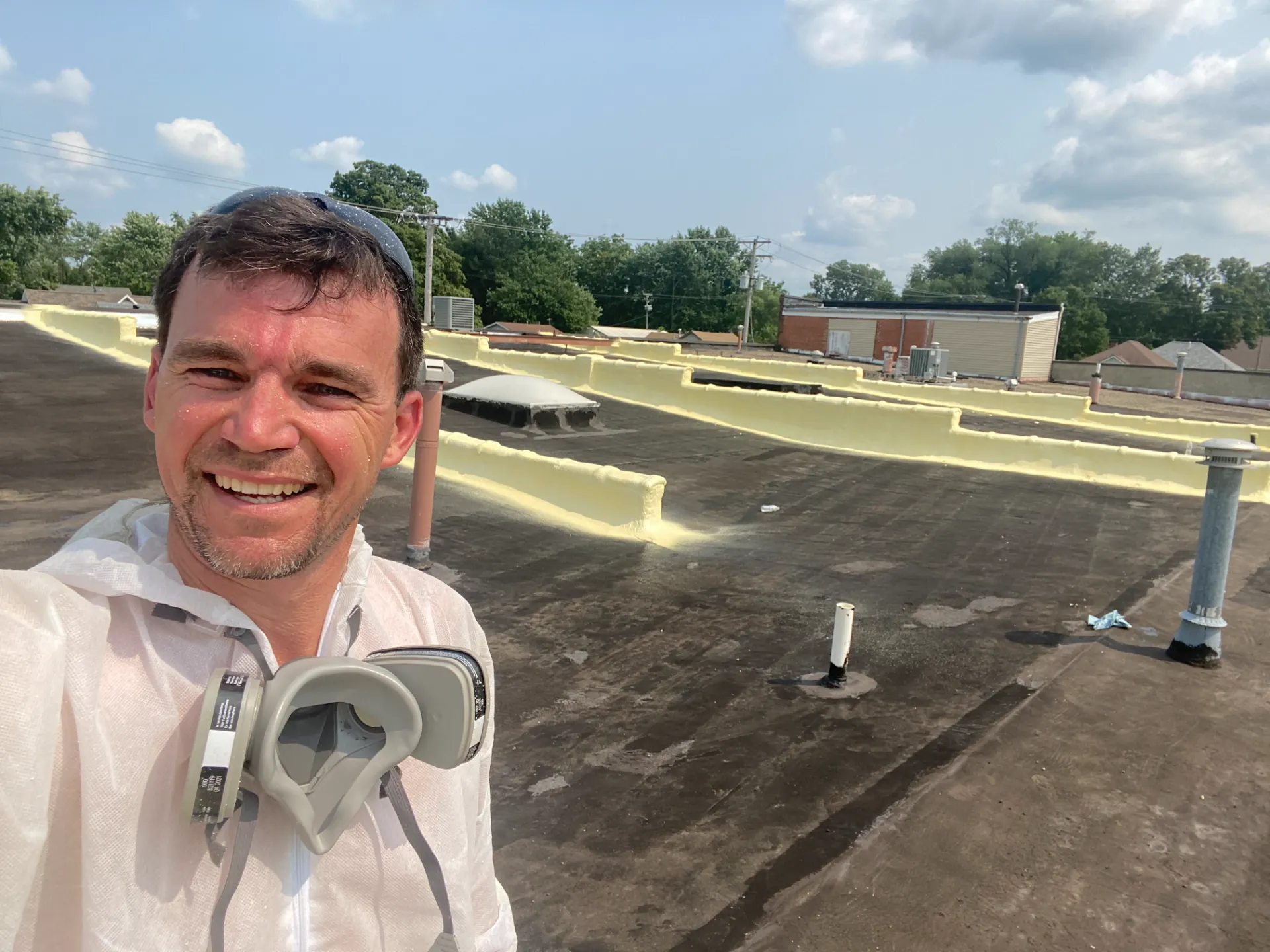 David taking a selfie on roof after finishing commercial spray foam job